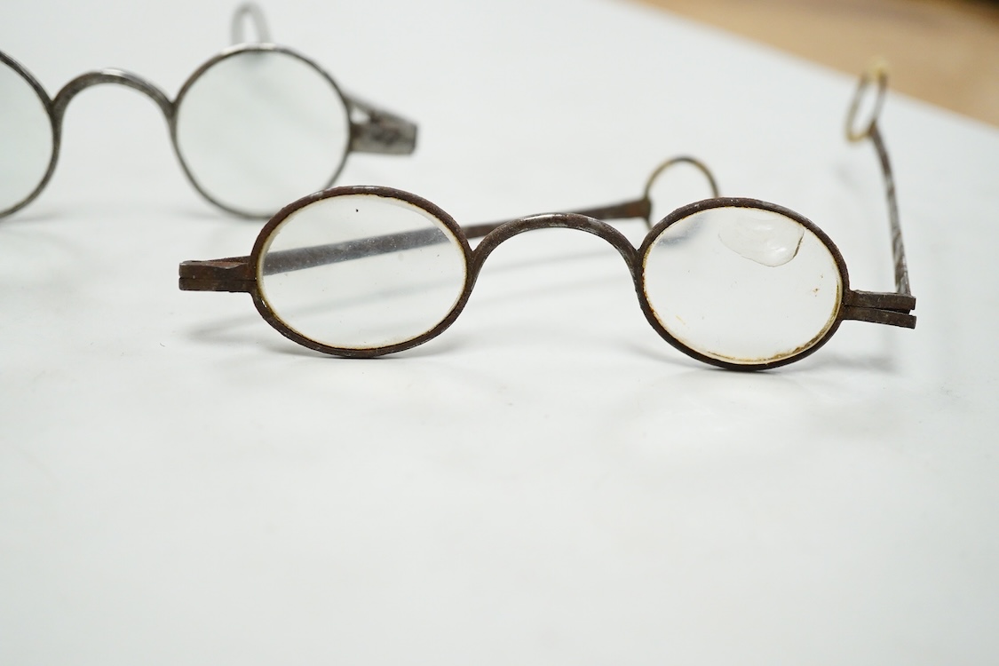 A pair of 18th century steel temple spectacles, a similar pair of iron spectacles, with written note dating them to 1796, and a pair of German? brass framed spectacles with green tinted lenses (3)